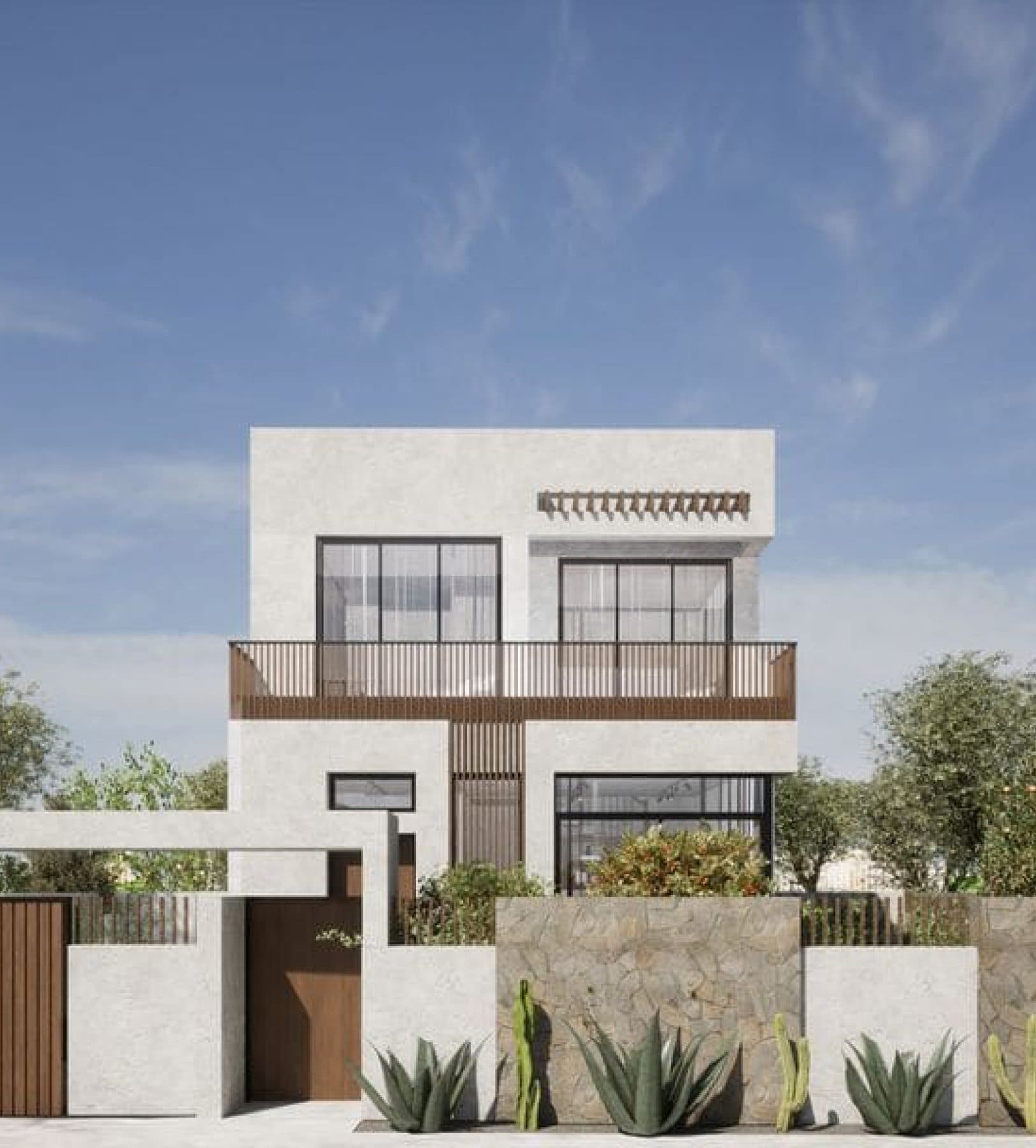 Villa contemporaine blanche derrière un mur de clôture planté d'agaves