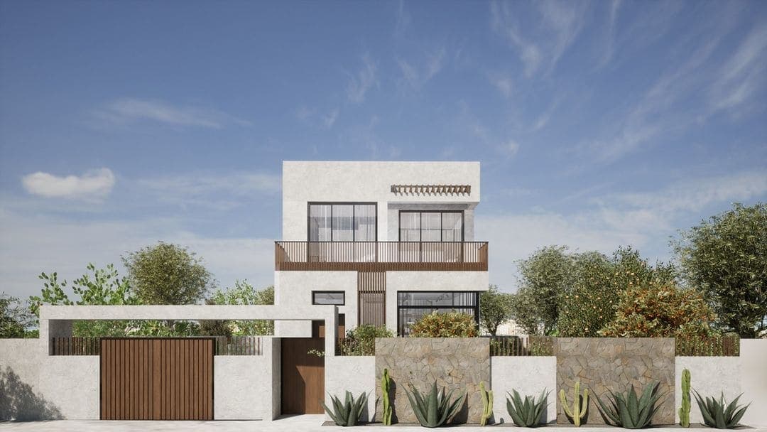 Maison moderne à deux étages avec un toit plat, de grandes fenêtres et un extérieur blanc avec des accents bruns. Conçue par un architecte de style Marrakech, la cour avant présente des murs blancs et en pierre, des cactus, des plantes vertes et un ciel clair avec quelques nuages.