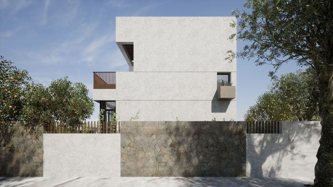 Un bâtiment blanc, moderne et minimaliste, conçu par un architecte de Marrakech, se dresse derrière un mur de pierre et de blanc, entouré d'arbres verts sous un ciel bleu limpide.